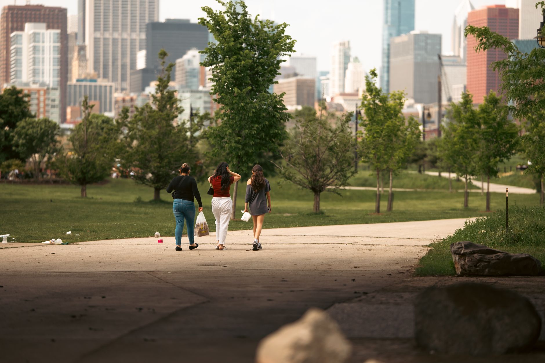 Person walking slowly through urban green space for mood benefits on a grey British afternoon